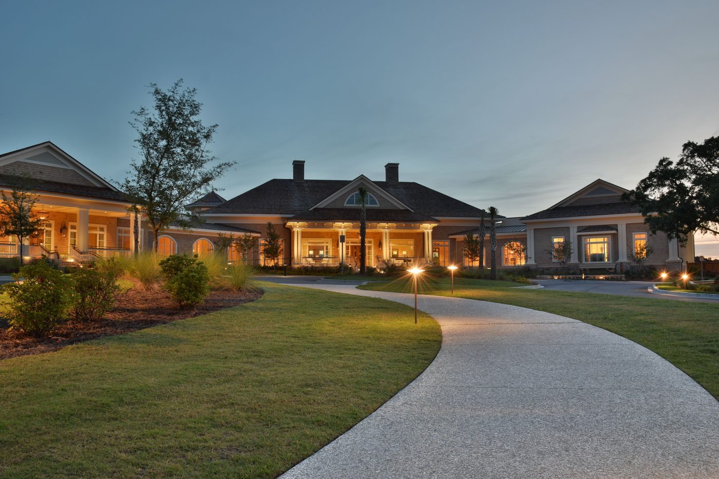 Golf clubhouse verandahs glowing at dusk