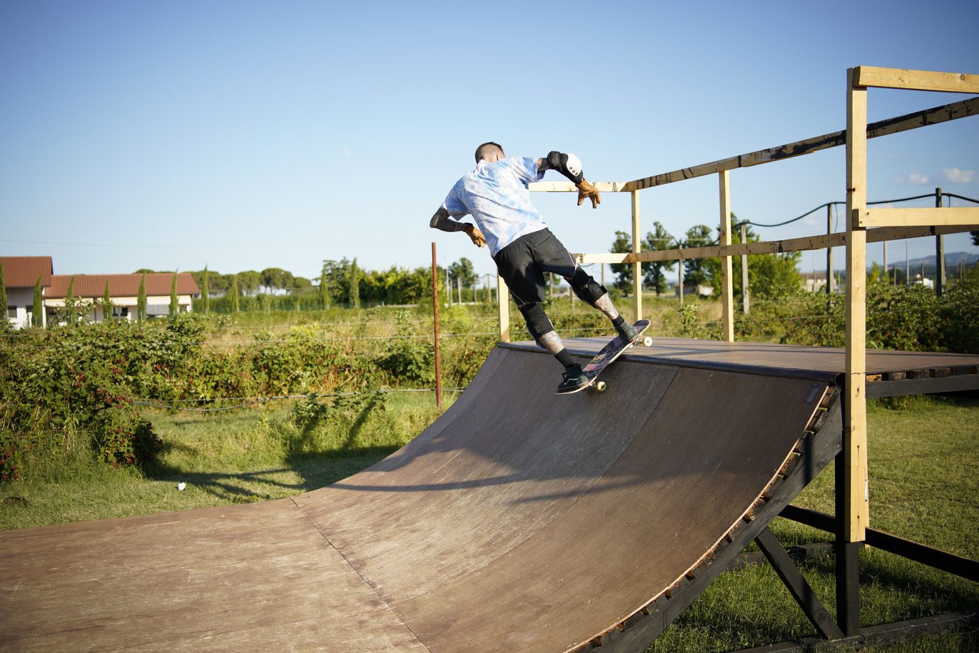 Skater riding a wooden mini ramp outdoors