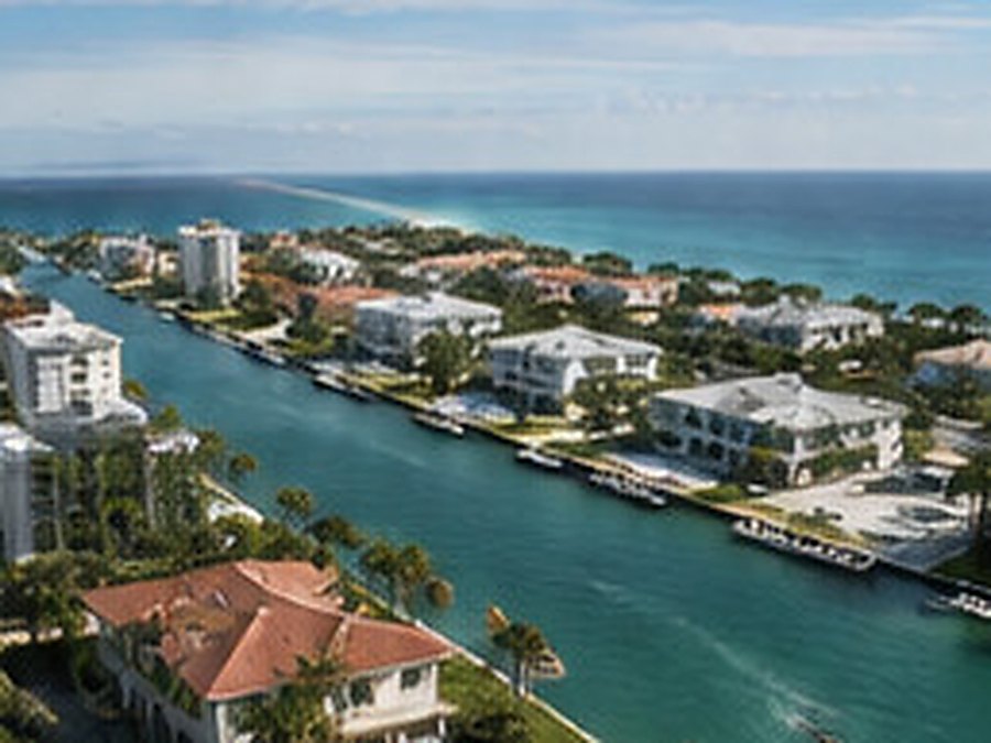 Aerial view of a coastal waterway lined with houses, docks and moored boats