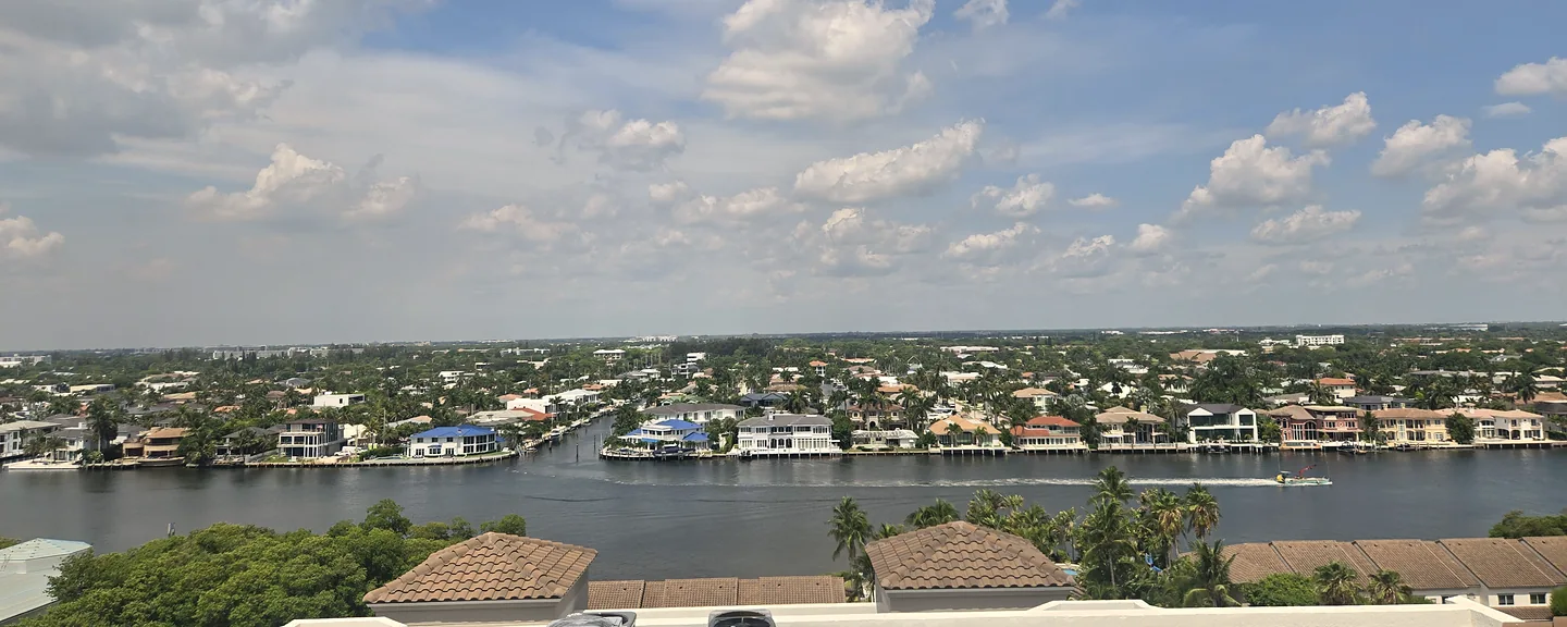 Illustrative Florida beachfront buildings and a pier at dusk