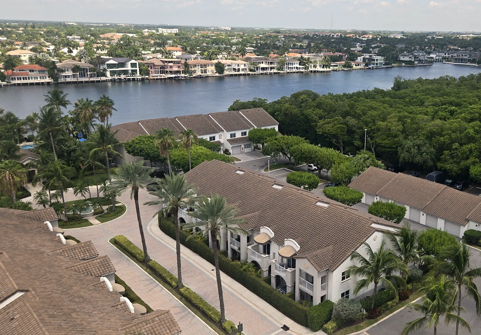 Waterfront villas and palms along the Intracoastal Waterway, seen from above
