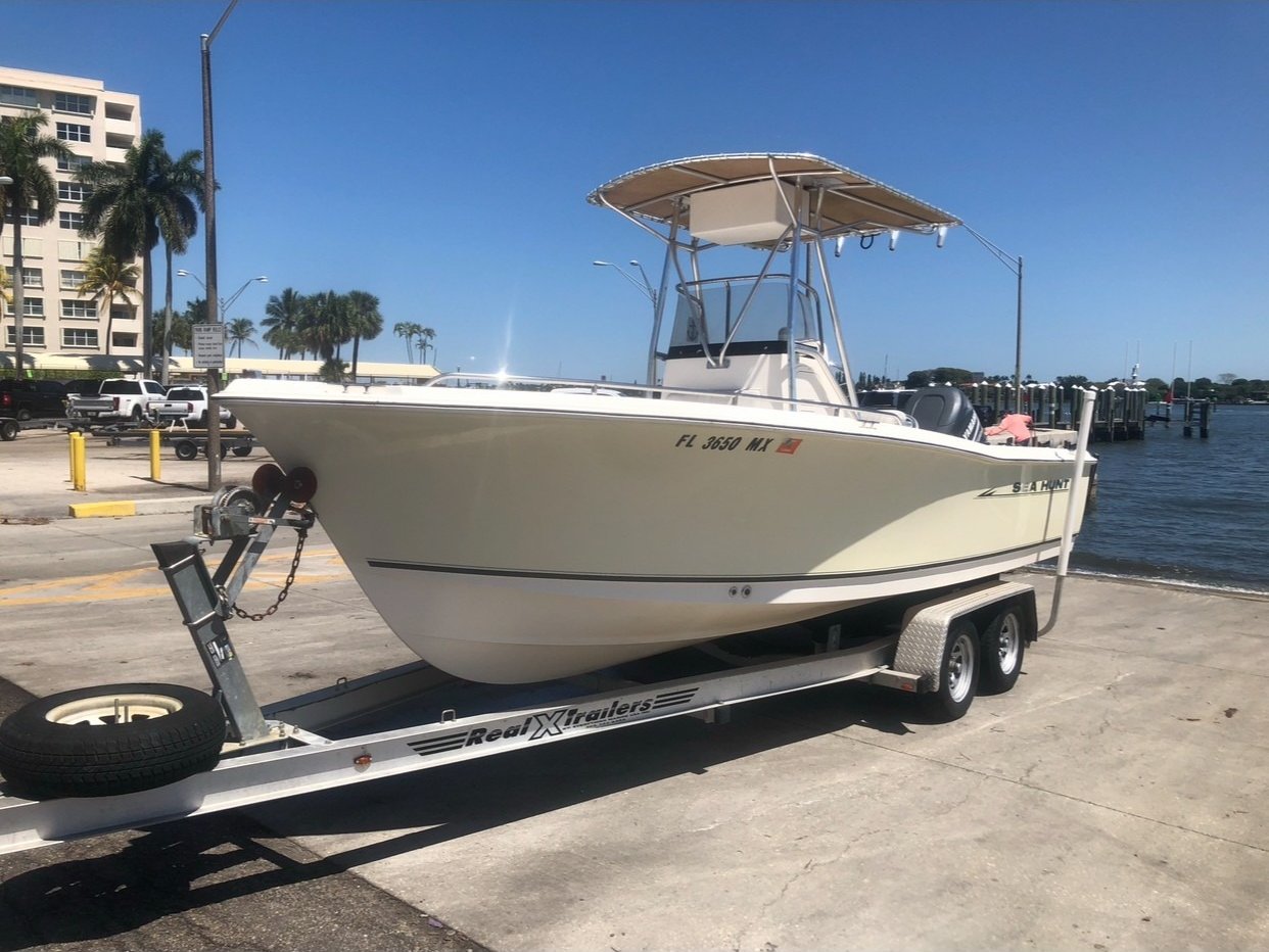 Captain Will's 21-ft Sea Hunt Triton 212 center console at a Palm Beach County boat ramp